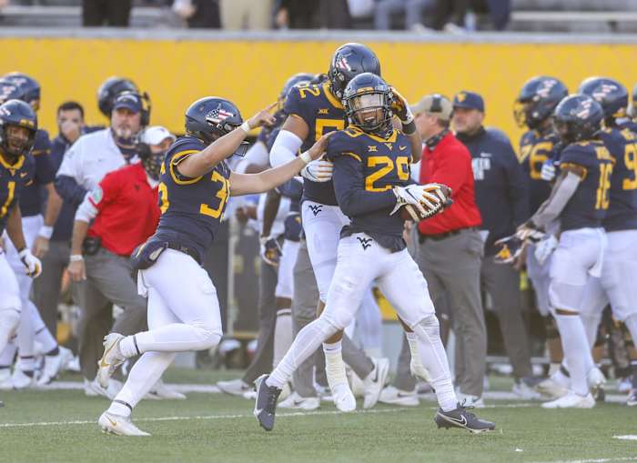 Nov 14, 2020; Morgantown, West Virginia, USA; West Virginia Mountaineers safety Sean Mahone (29) celebrates with teammates after recovering a fumble during the third quarter during the fourth quarter against the TCU Horned Frogs at Mountaineer Field at Milan Puskar Stadium.